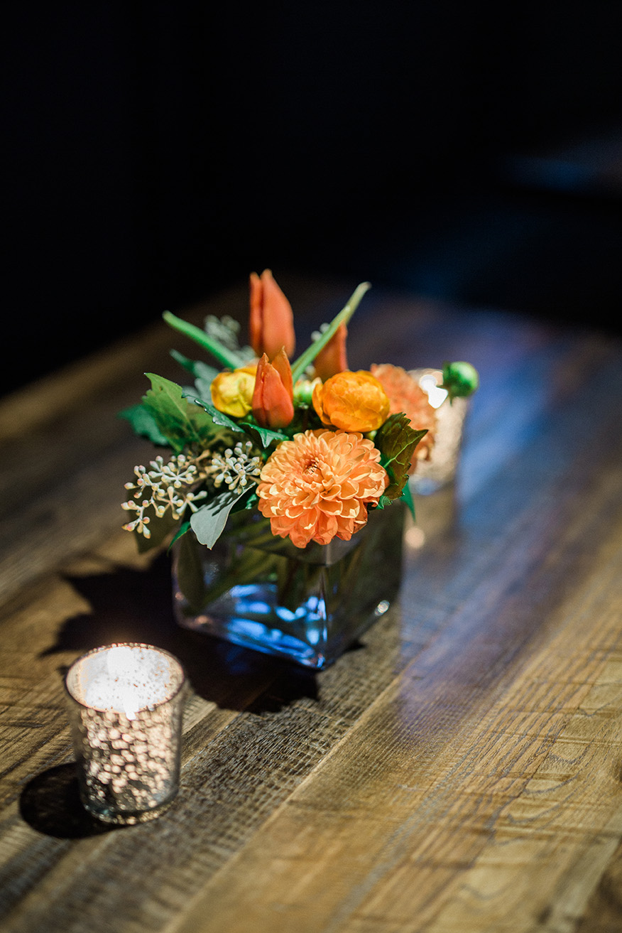 Small Orange Floral Centerpiece on Table
