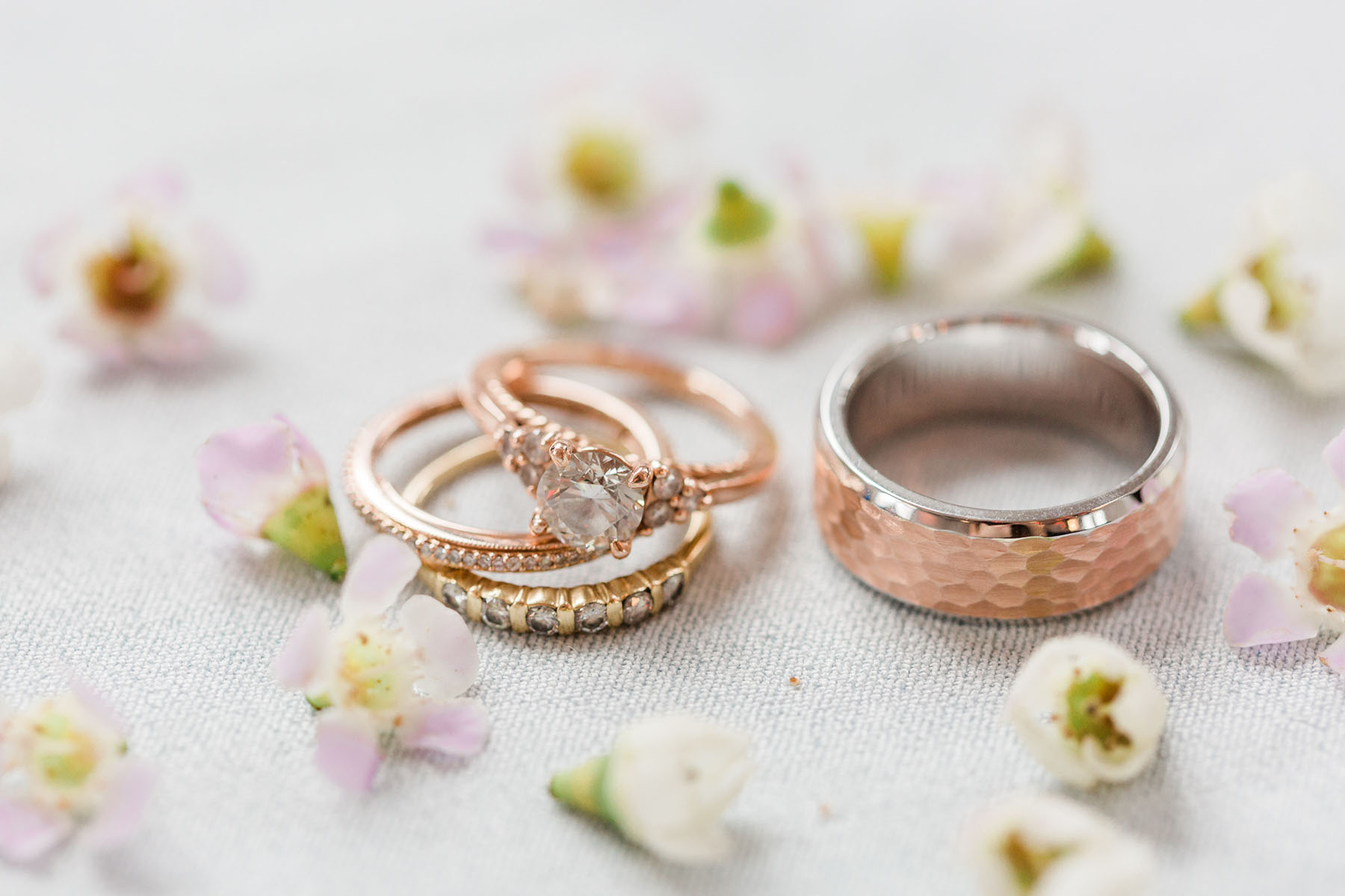 Rose Gold Wedding Rings With Flowers Flat Lay