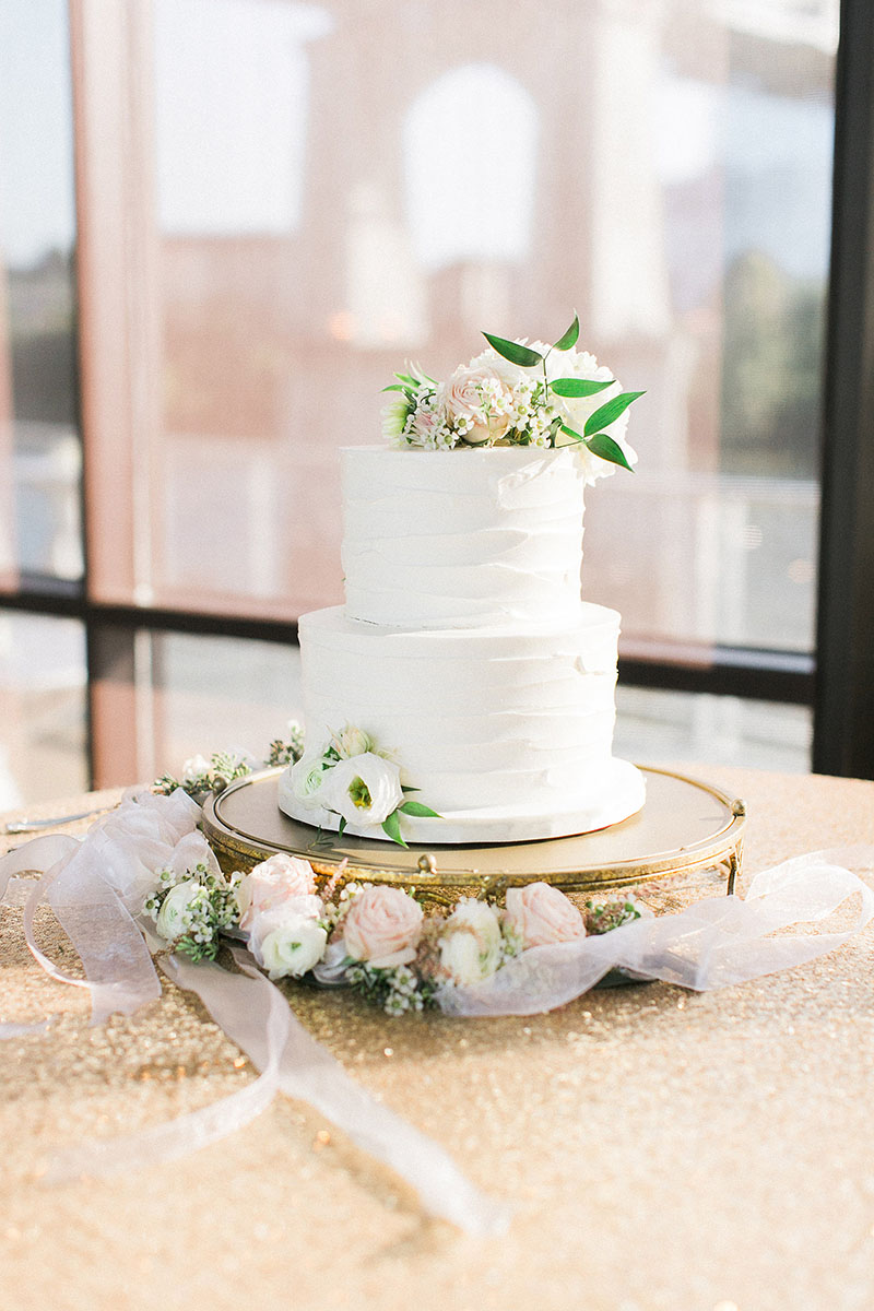 Two tier Wedding Cake sitting on gold sequin linen