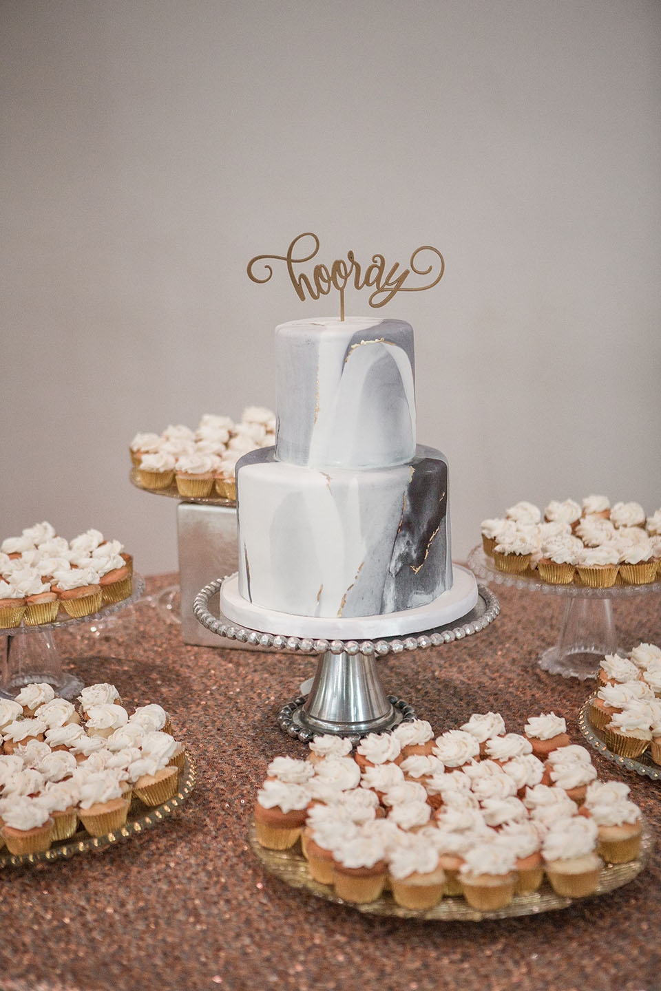Marbled Wedding Cake and Cupcakes on Dessert Table