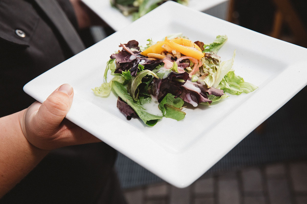 Server Holding Plated Salad