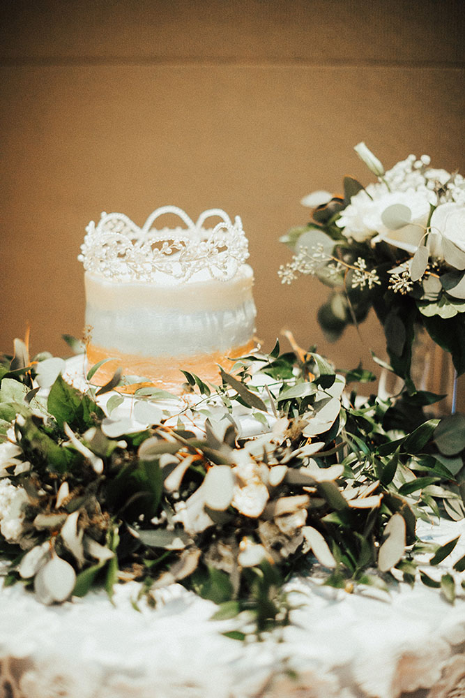 White and Gold Lace Wedding Cake with Greenery