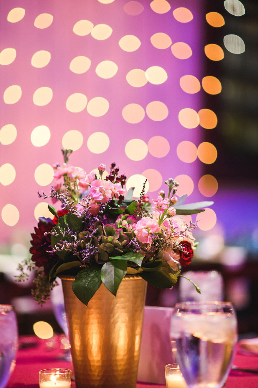 Burgundy Floral Centerpiece in Gold Vase