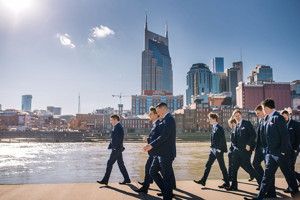 Jordan and Groomsmen Walking Along Riverfront