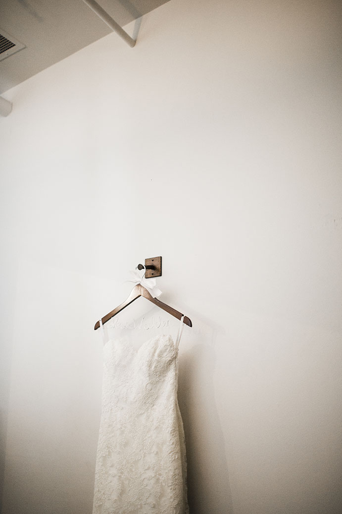 Jenna's Wedding Dress Hanging on the Wall