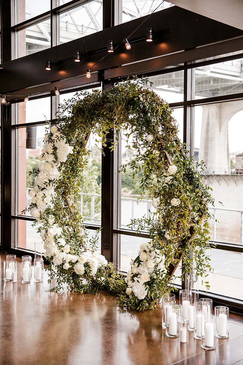 Geometric Greenery Arch with White Florals and Candles at Base