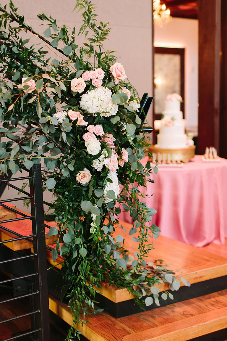 Romantic Wedding Florals Adorning Staircase Rail