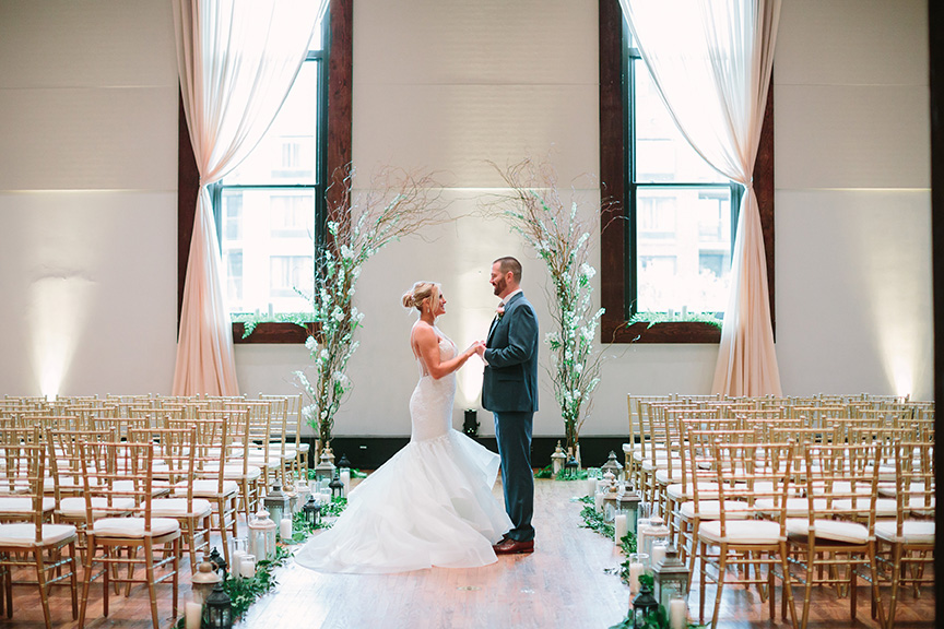 Rachel and Kevin Holding Hands at Altar