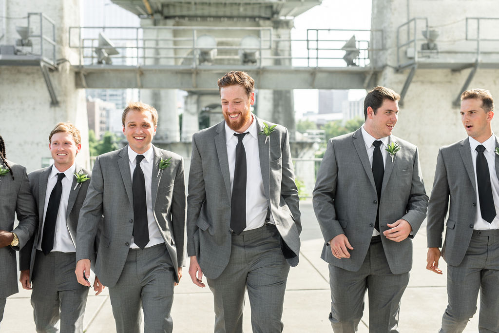 John and Groomsmen Laughing Under Pedestrian Bridge