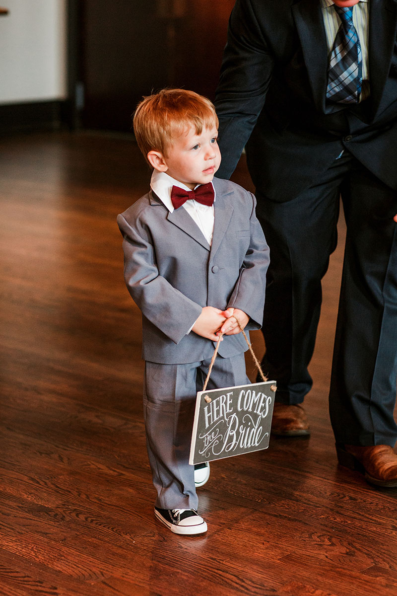 Ring Bearer Holding Here Comes The Bride Sign