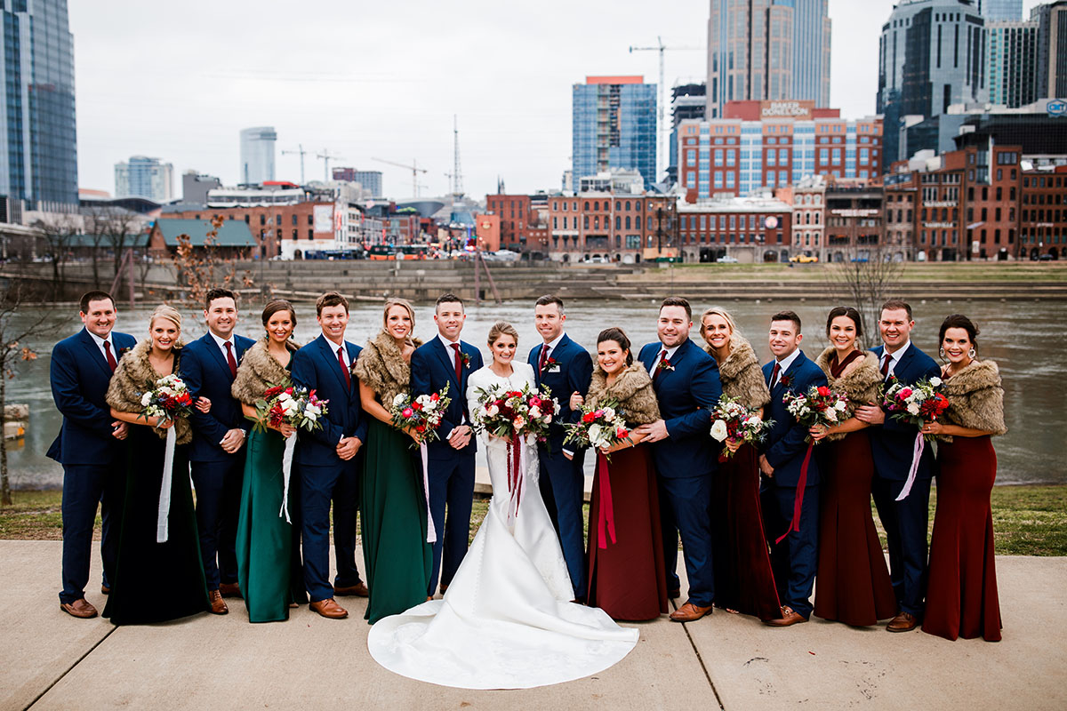 Jenna and Dave Posing with Wedding Party on Riverfront