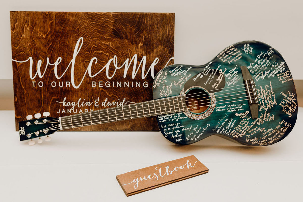 Unique Personalized Guitar Guest Book Sitting Next to Wood Welcome Sign