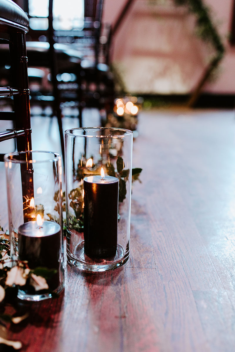 Black Pillar Candles Lining Wedding Aisle