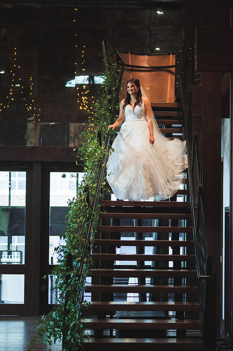 Bride walking down Bell Tower staircase during wedding ceremony processional