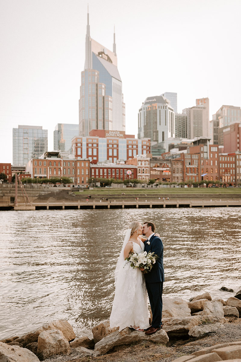 Chelsea and Scott Kissing on the Riverfront