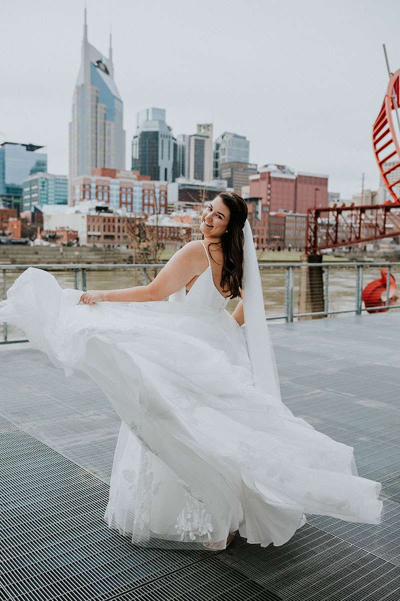Molly Spinning in Wedding Dress on Riverfront