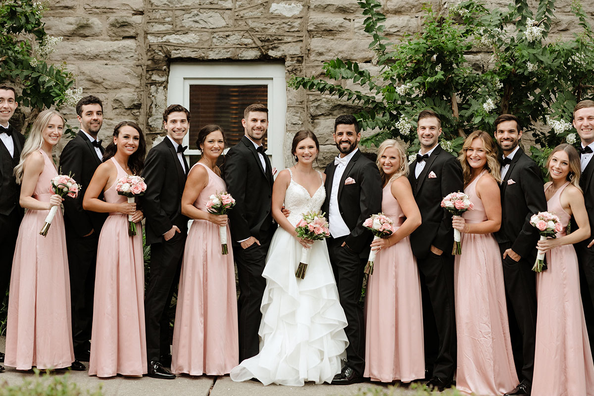 Bride and groom pose with entire wedding party