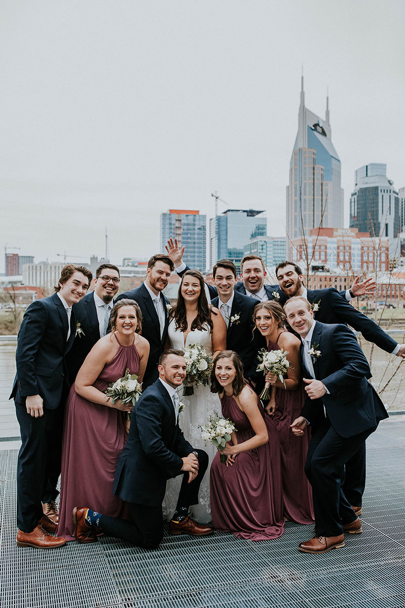 Molly and Sean Standing with Wedding Party on Riverfront