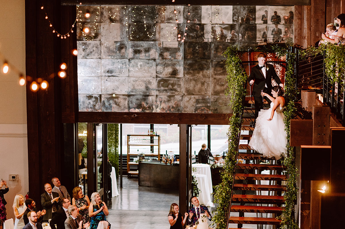 Sarah and Patrick's enter the reception down a mezzanine staircase at the Bell Tower in Nashville