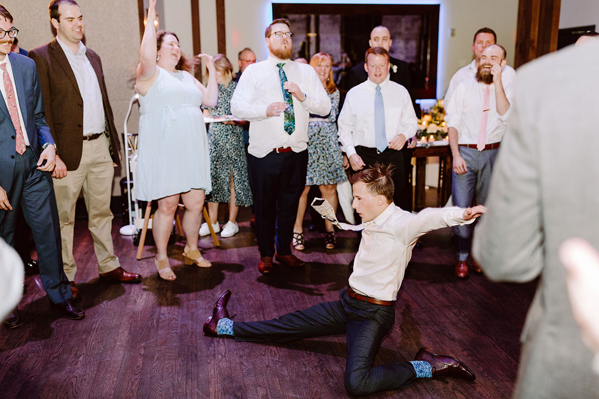 A wedding guest breaks it down on the dance floor as other guests cheer around him at the Bell Tower in Nashville