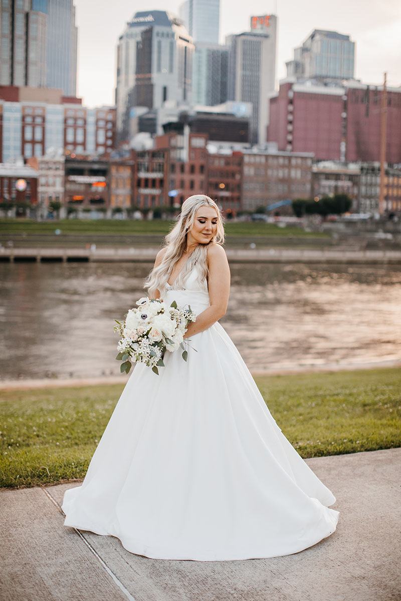 Cassidy Posing on the Riverfront Holding Bridal Bouquet