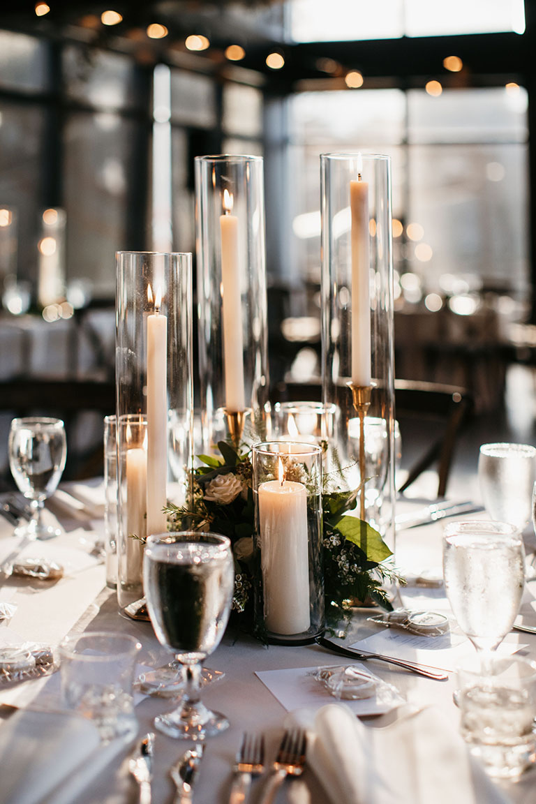 Dreamy Wedding Reception Centerpiece with Greenery and Gold Taper Candles