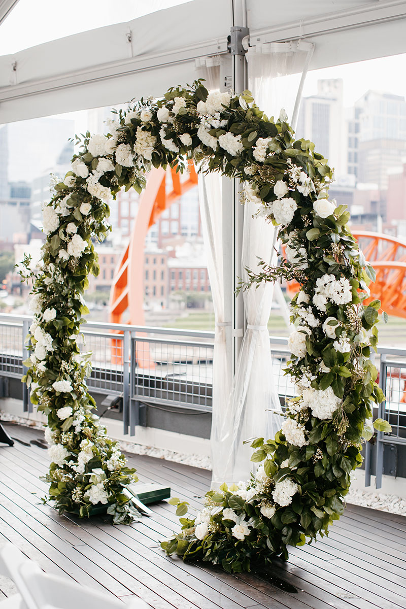 Circular Wedding Ceremony Floral Arch Sitting on Rooftop