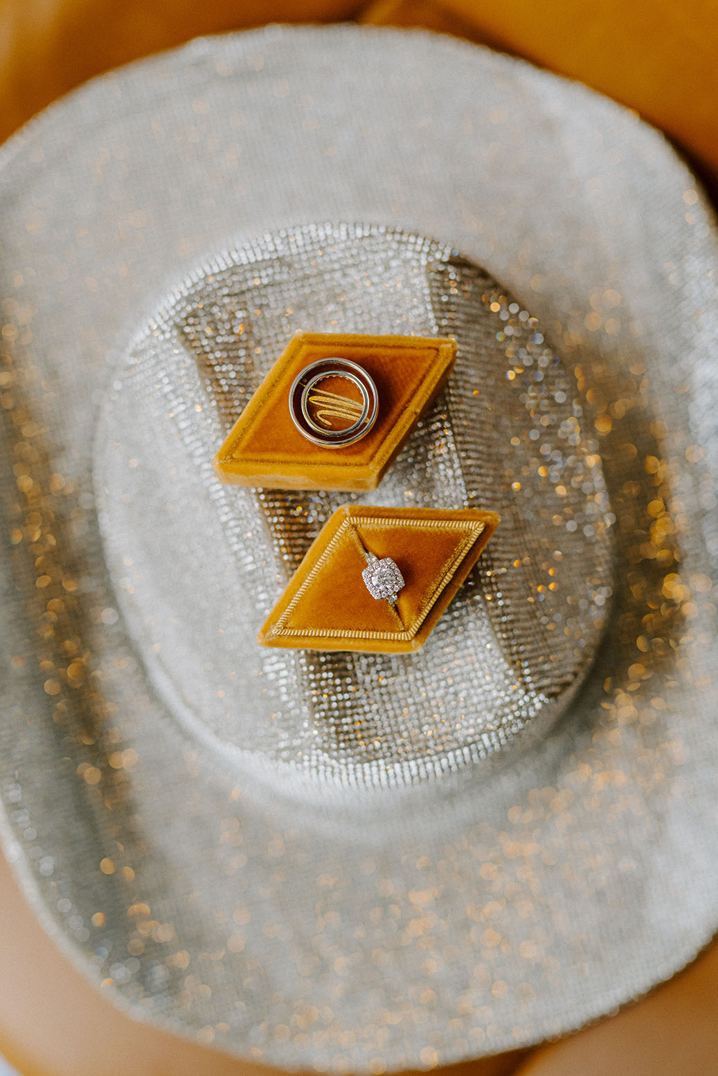 Rhinestone Cowboy Hat and mustard velvet wedding ring box flat lay