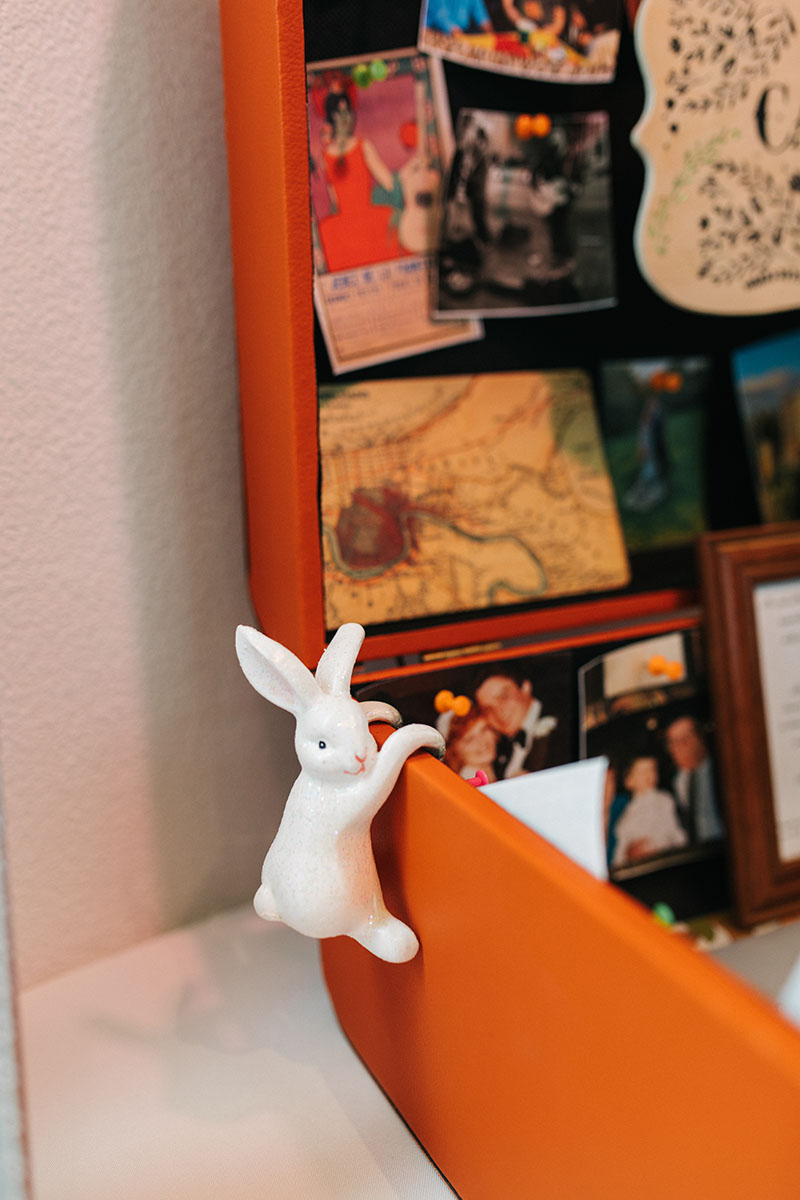 Porcelain Rabbit Hanging Over the Edge of Suitcase