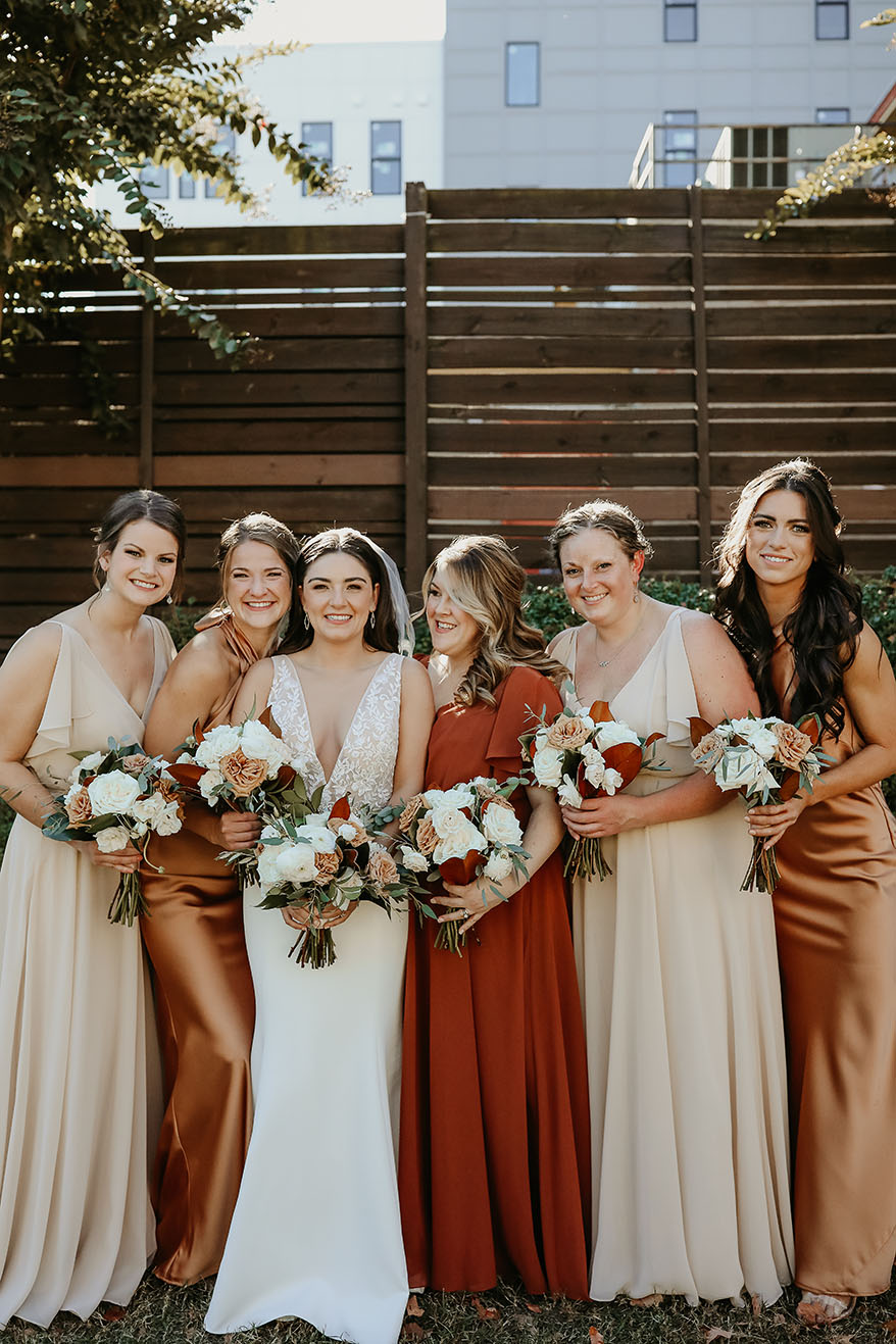 Kate and Her Bridesmaids in Orange, rust, and neutral dresses