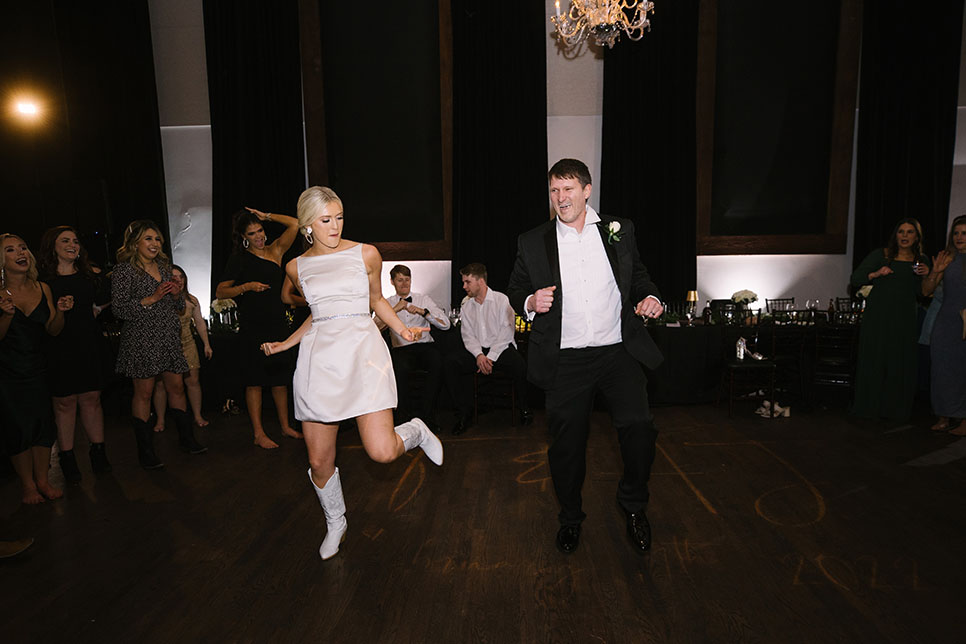 Reception dancing bride changed to a short white dress with cowboy boots