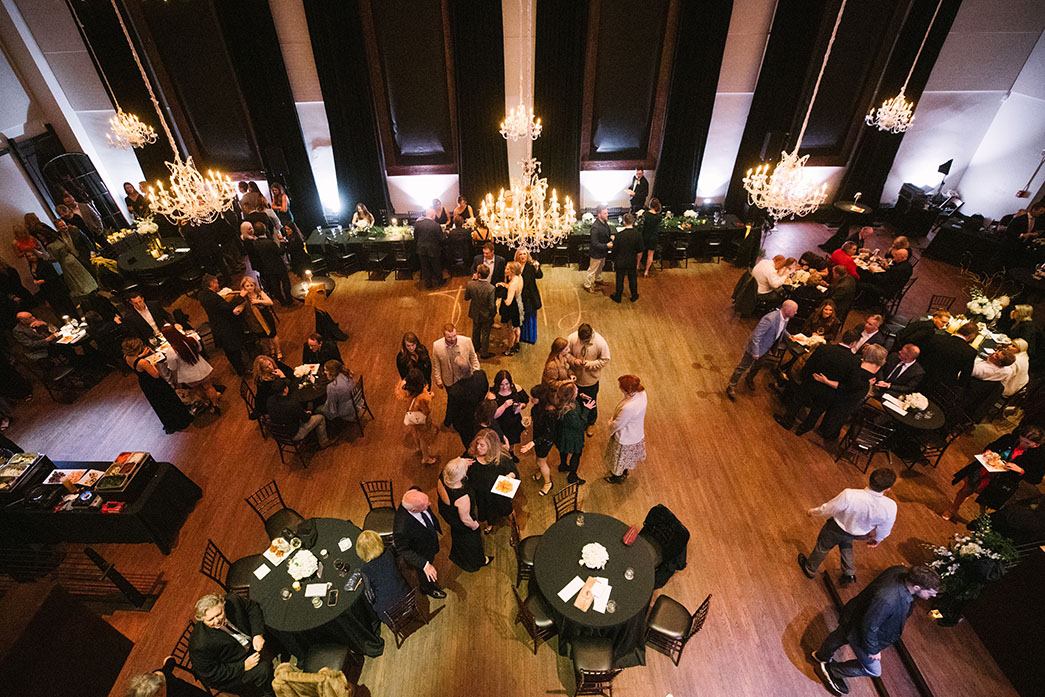 Classic Black Tie Wedding Reception with Hanging Glamorous Chandeliers, String Lighting, and Moody Black Drapes | Historic Downtown Nashville Wedding Venue | Black Wedding Aesthetic