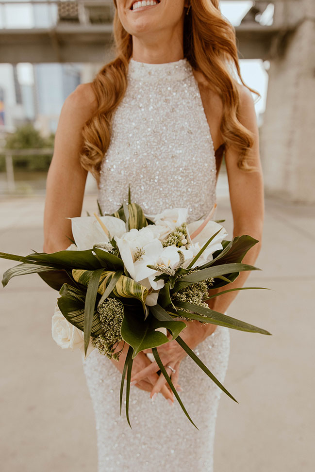 Bride holding tropical wedding bouquet