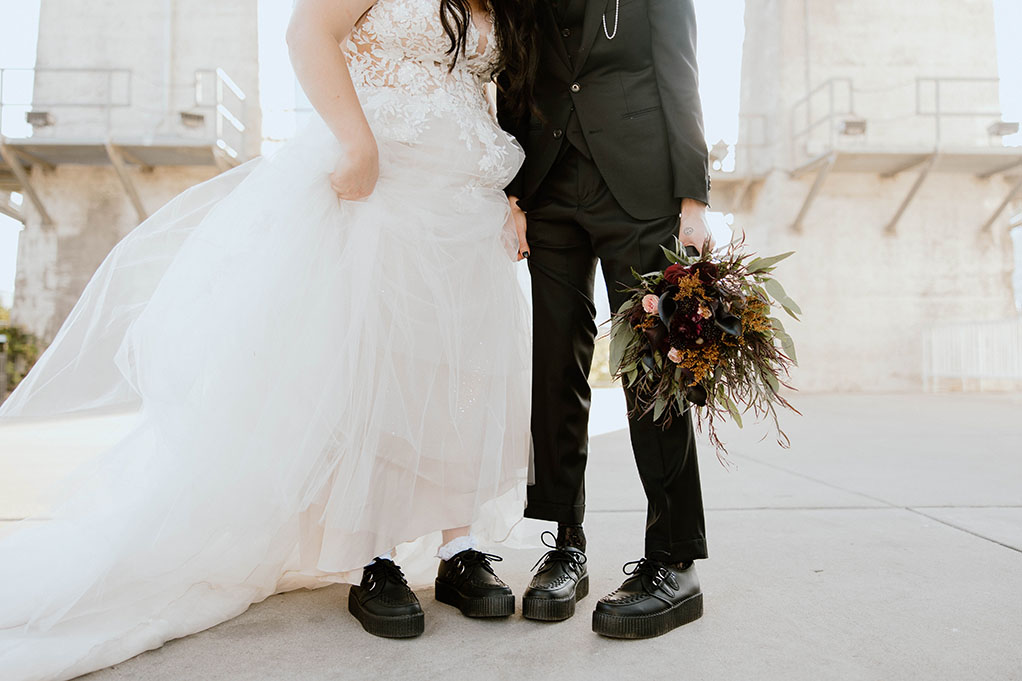Bride and groom wearing black leather creepers on their moody October wedding day