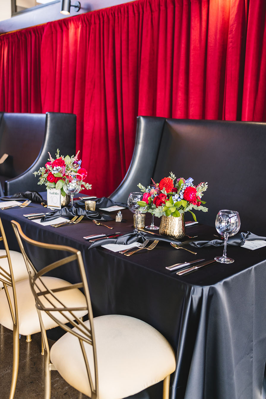 Black and Gold Table Setting with Red Velvet Draping