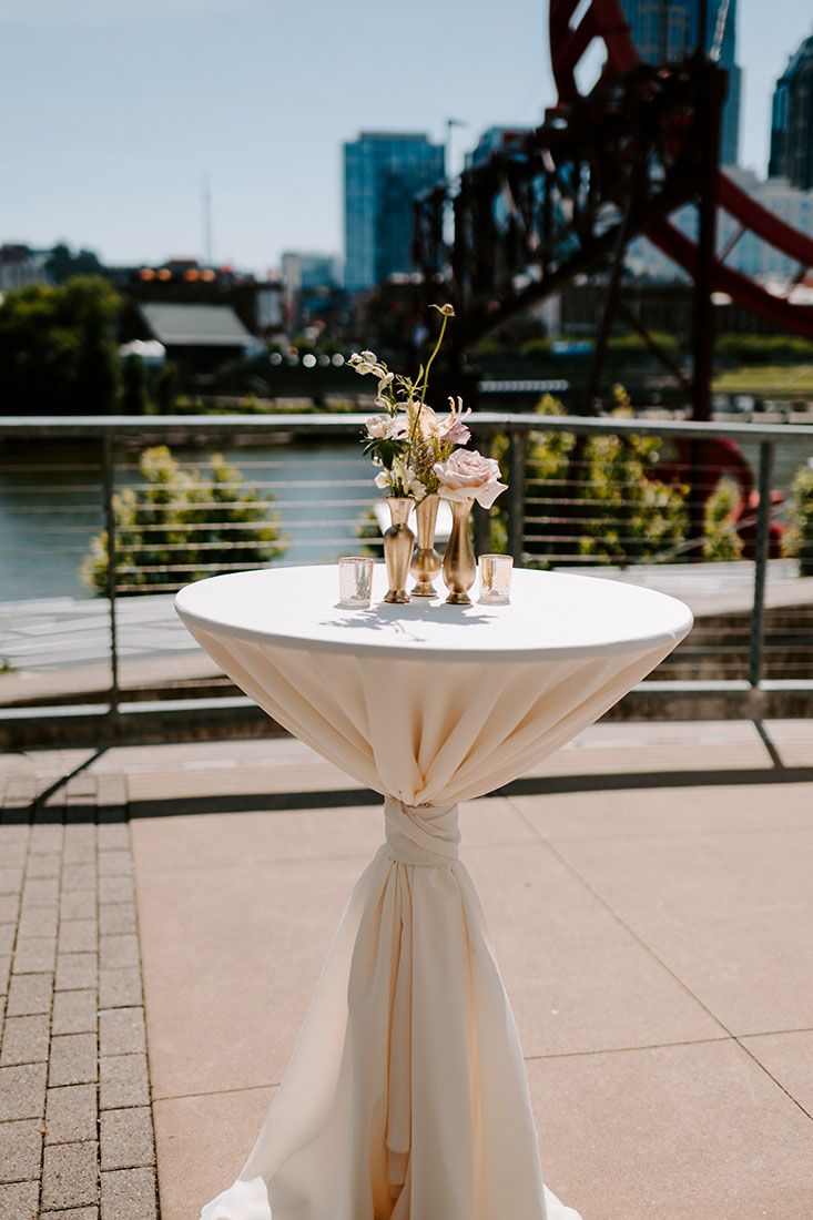 Neutral Linen Adorned Cocktail Tables on Riverfront Patio in Downtown Nashville