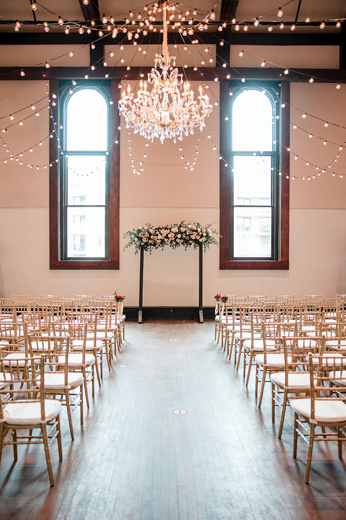 Ceremony Setup with Maria Chandelier, Cascading String Lights, and Wood Arch