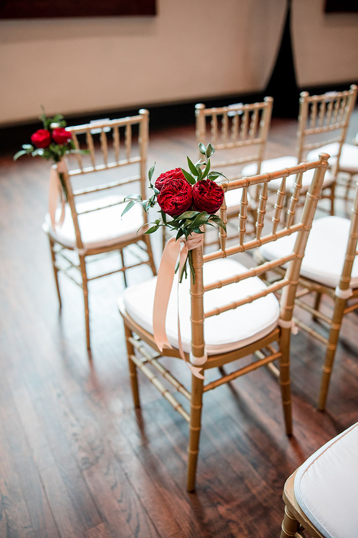 Ceremony Chairs with Red Roses Down the Aisle