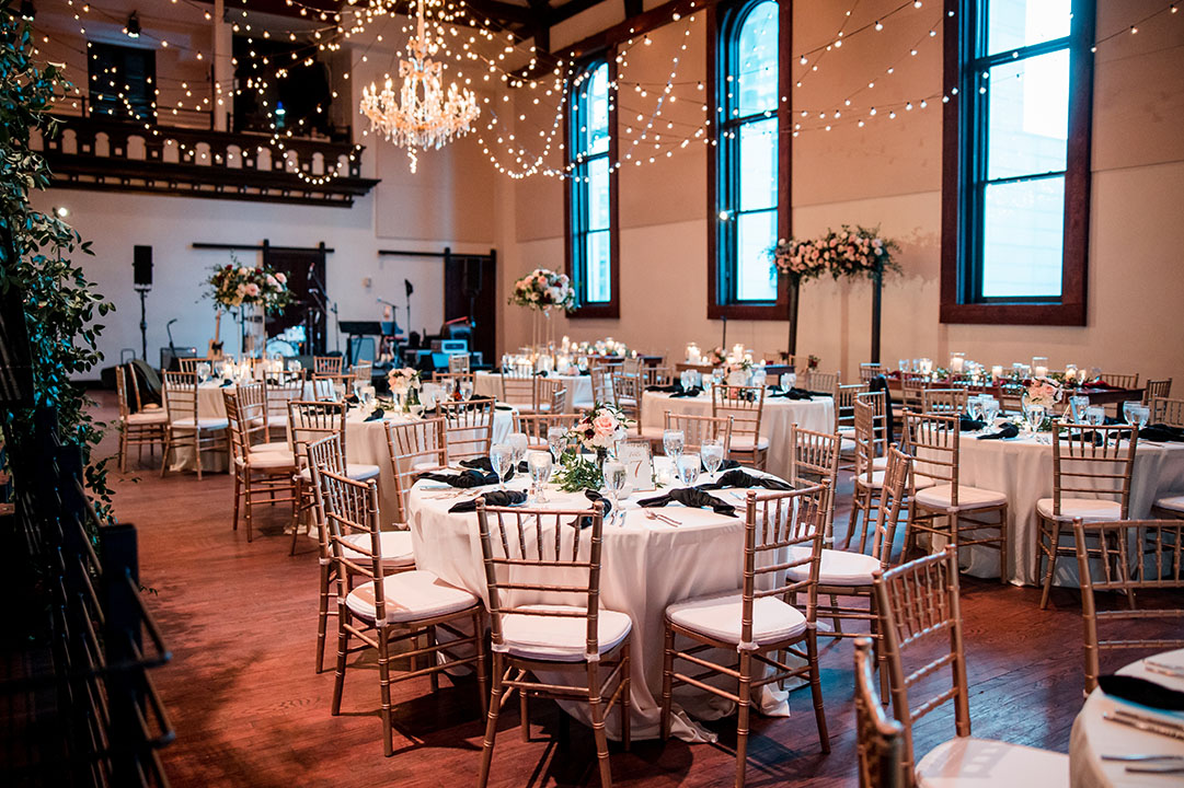 Romantic Glam Reception Setup at The Bell Tower with Gold Chairs, White Table Linens and a Chandelier