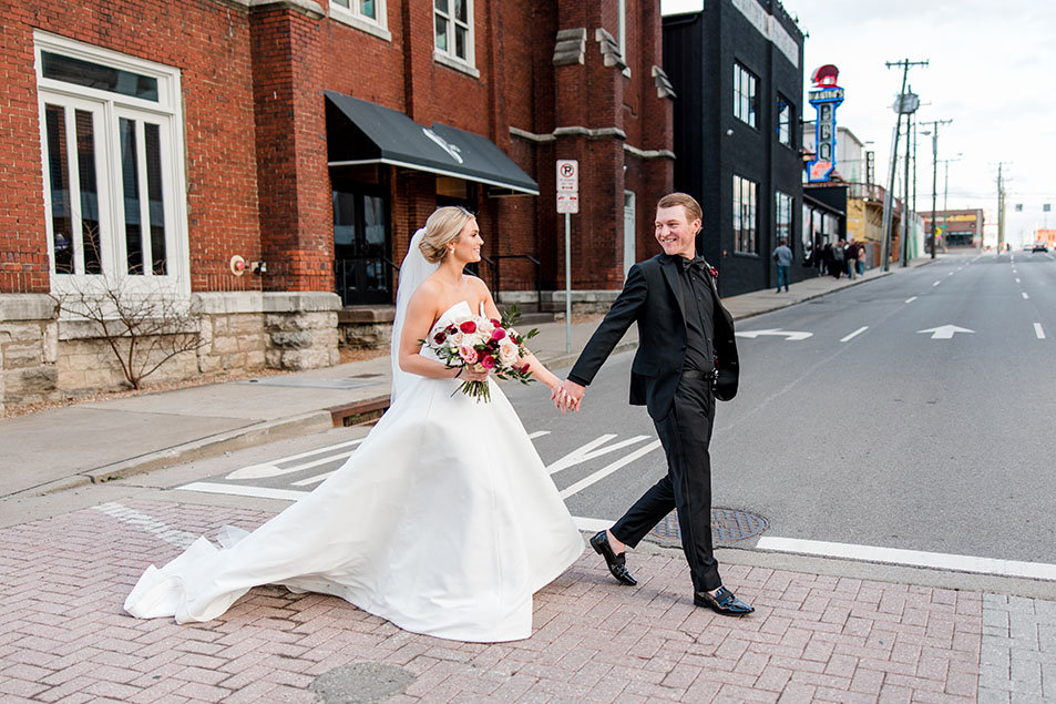 Bride and Groom Walking Across the Street from Venue