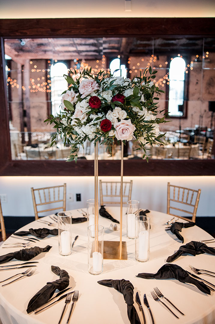 Reception Table Setting with Black Napkins and Rose-filled Centerpiece