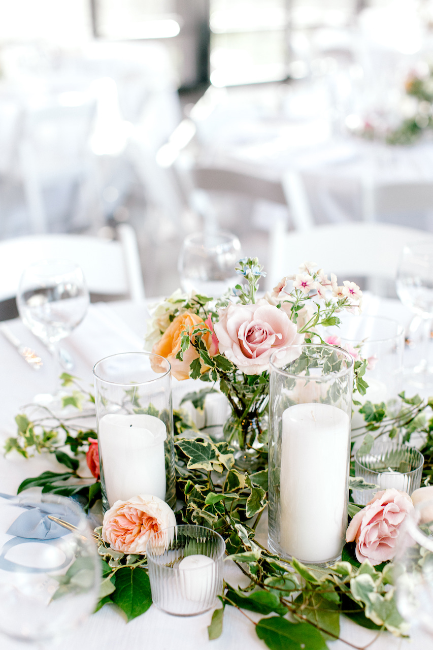 Pastel floral centerpiece with pillar candles