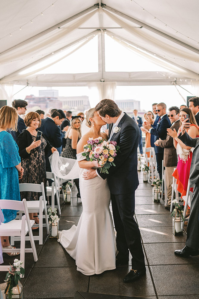 Emily and Tyler Kissing at the End of the Aisle During Wedding Ceremony in Downtown Nashville