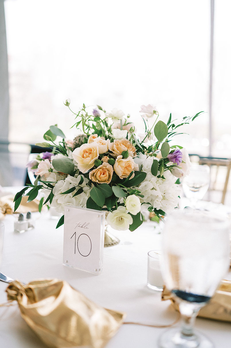 Reception Table Setting with Gold Favor Bags and Greenery Centerpiece