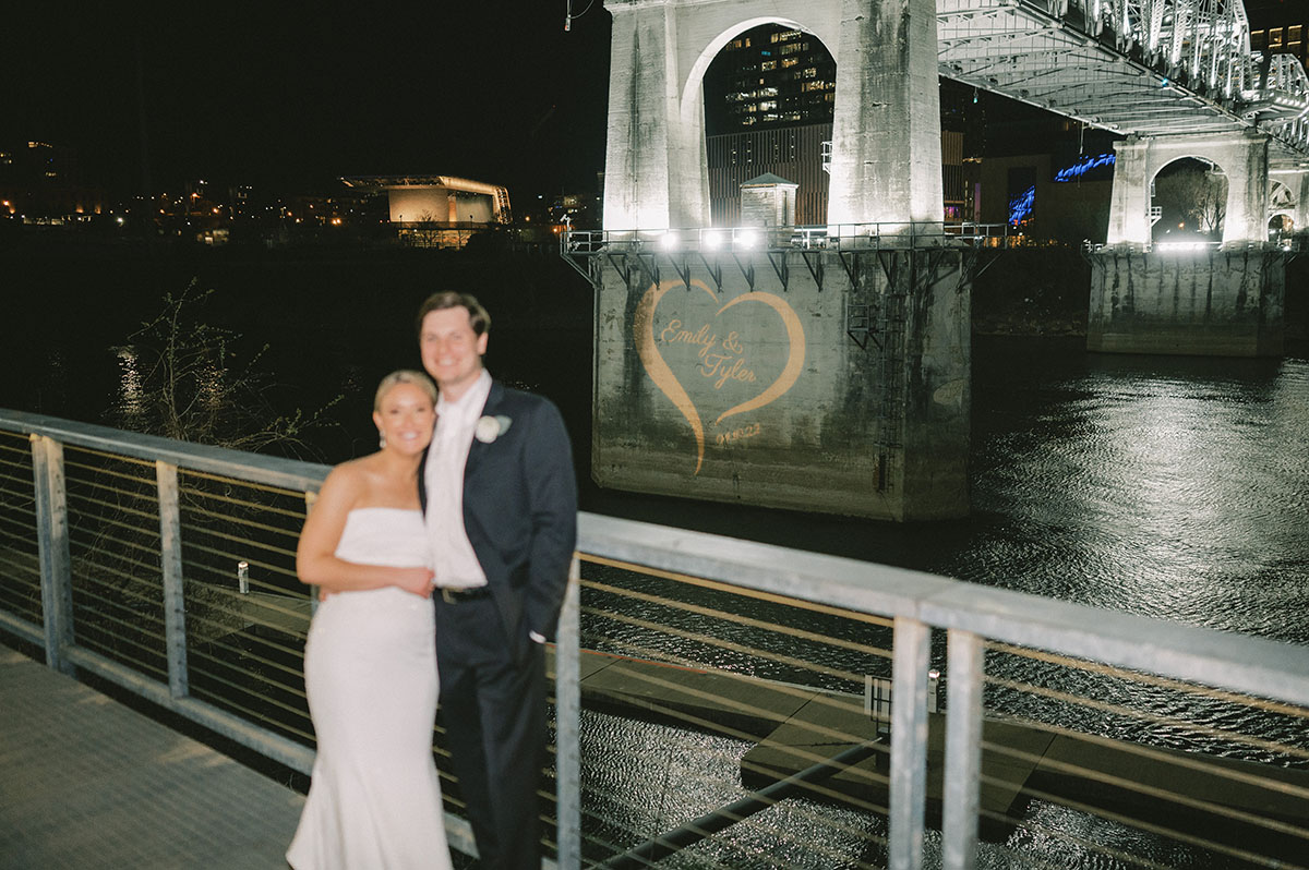 Emily and Tyler Standing in front of their Custom Gobo for Whimsical Wedding in Downtown Nashville