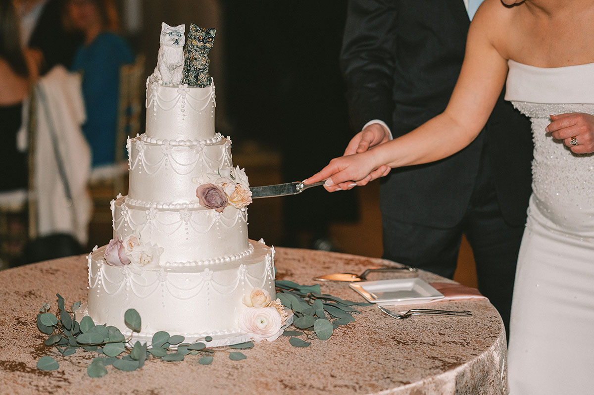 Emily and Tyler Cutting their Four Tiered Whimsical Wedding Cake