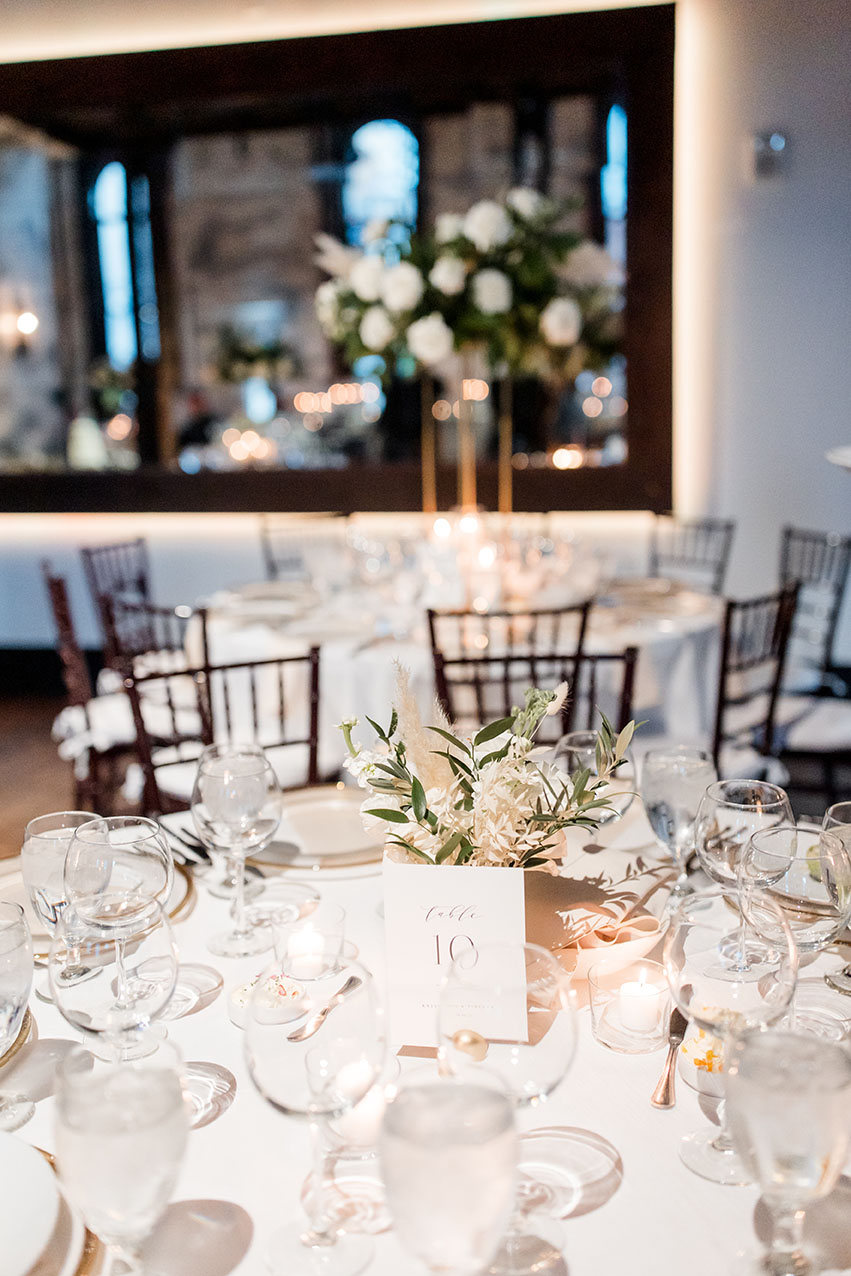 reception set up with white linens and florals