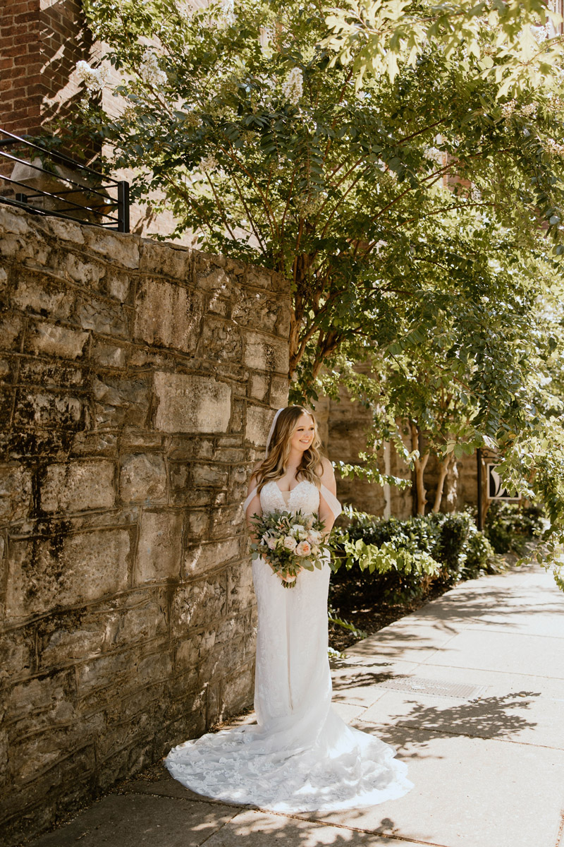 bride poses outside historical old church turned wedding venue in downtown nashville