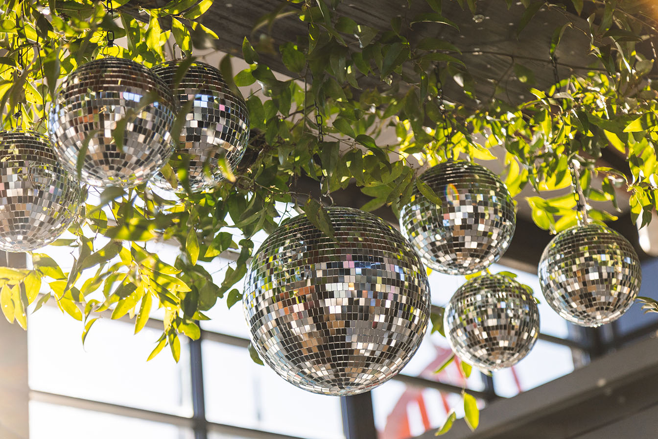 Greenery Install with Disco Balls in Cumberland Space for Reception