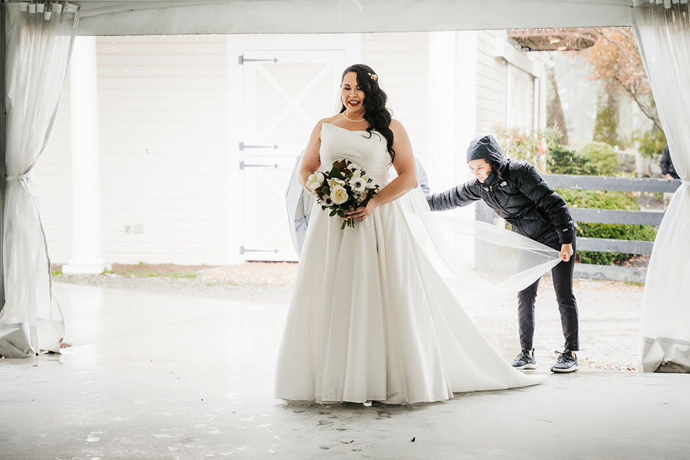 Priscilla Adjusting Bridal Veil at Outdoor Wedding